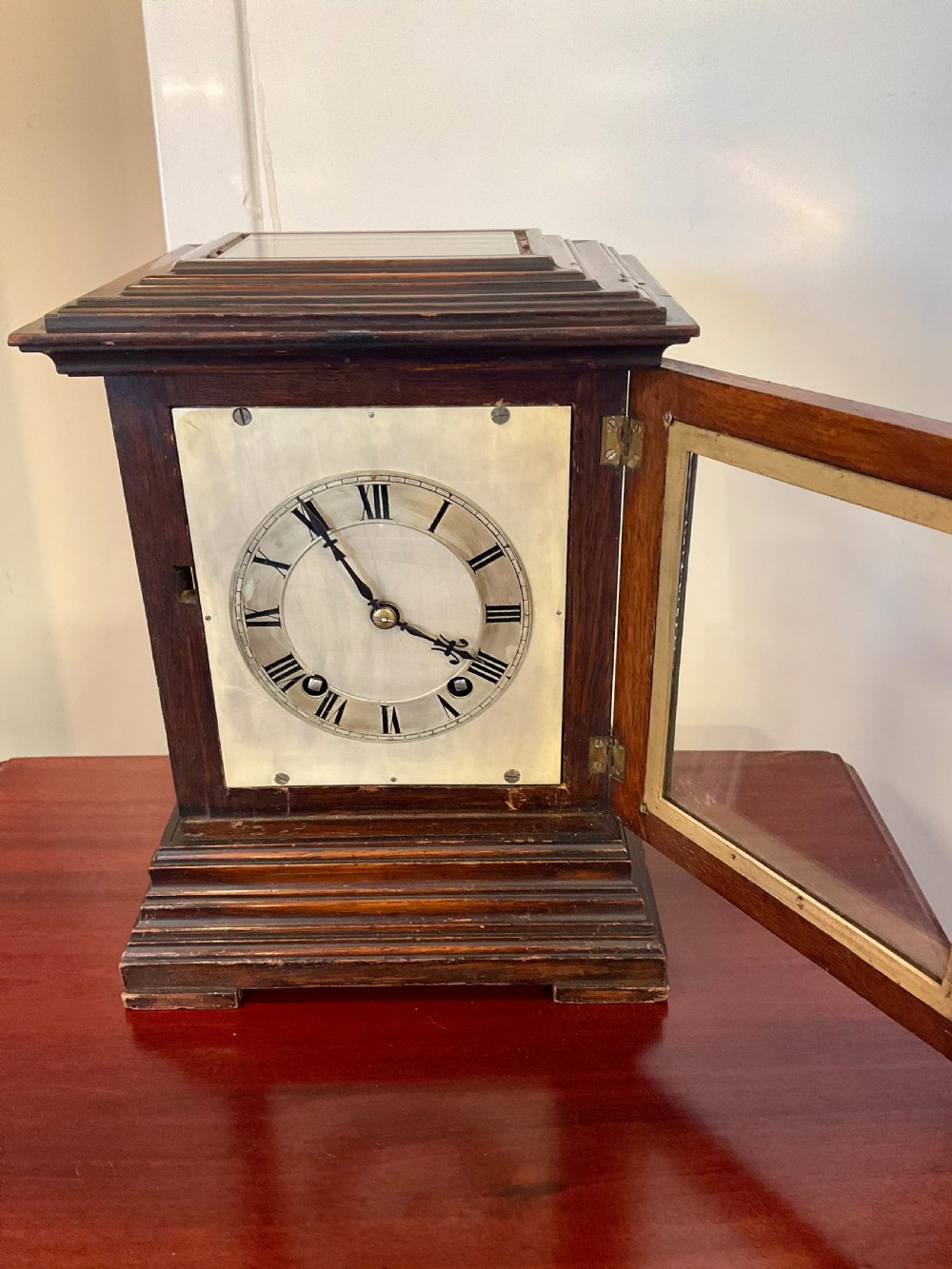 A Victorian dark mahogany five-glass bracket clock featuring a square white dial with Roman numerals and a stepped moulded base. View V