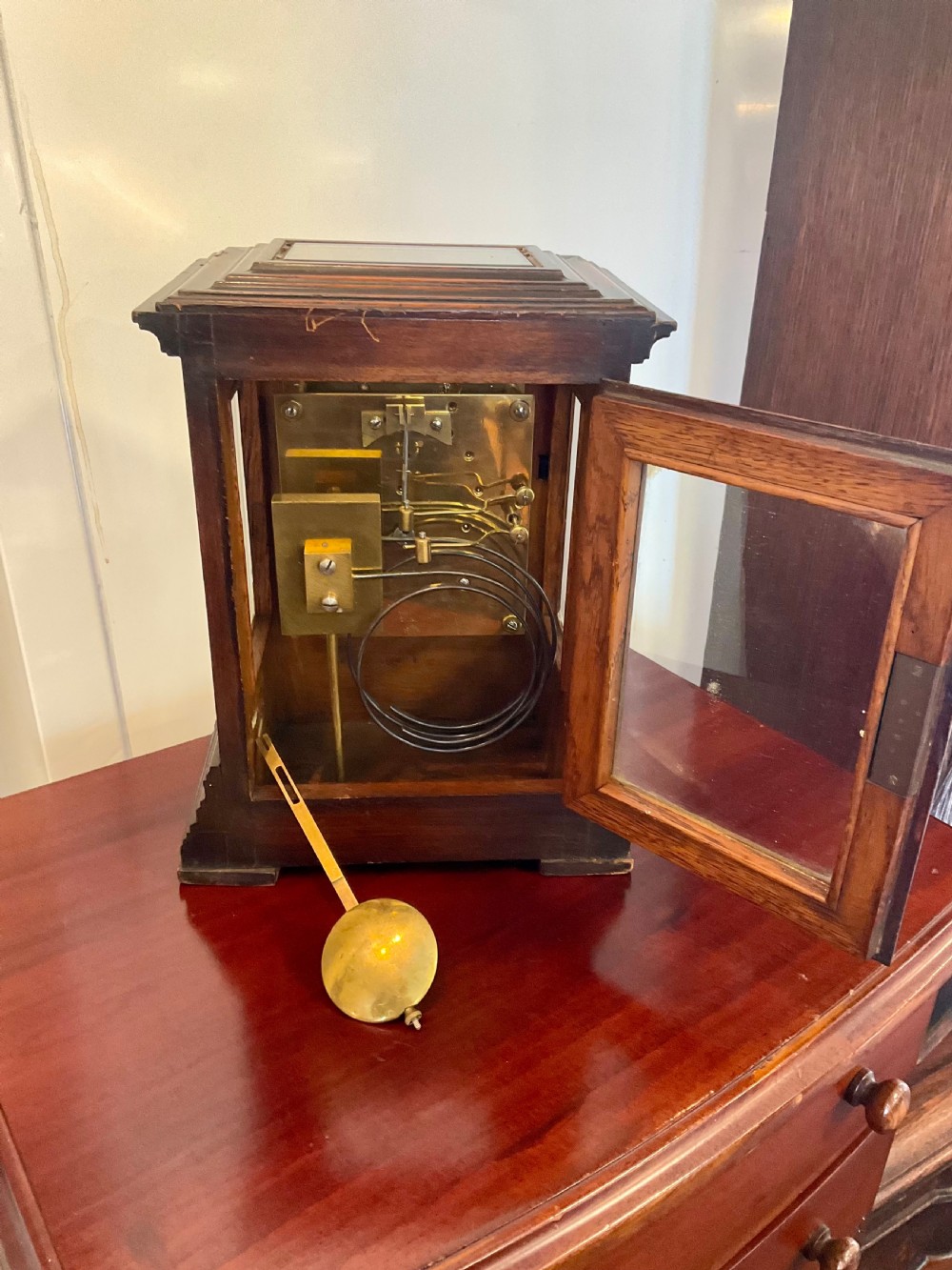 A Victorian dark mahogany five-glass bracket clock featuring a square white dial with Roman numerals and a stepped moulded base. View VI