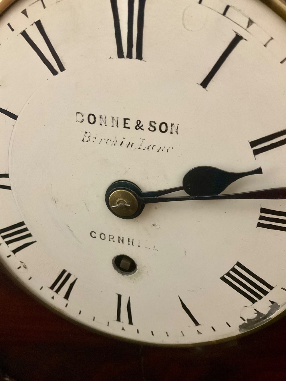 A 19th-century mahogany fusee bracket clock featuring an arched case with hand-carved floral spandrels, flame mahogany veneer, and a circular cream dial with Roman numerals. View IX