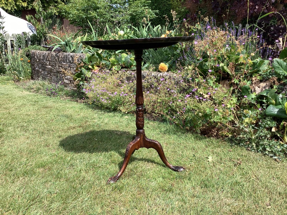 A dark mahogany tripod table featuring a scalloped piecrust tilt-top surface, turned column stem, and carved cabriole legs. View VIII