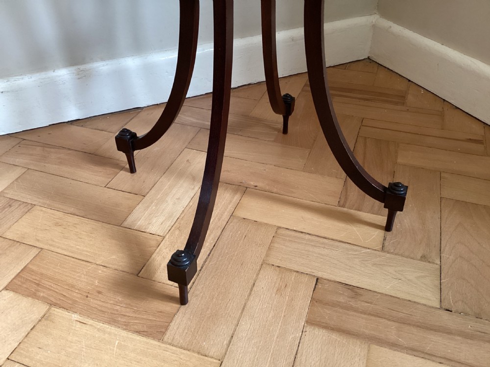 A dark mahogany occasional table featuring a concave square top surrounded by a pierced fretwork gallery, supported by four out-swept legs joined by an X-stretcher. View III