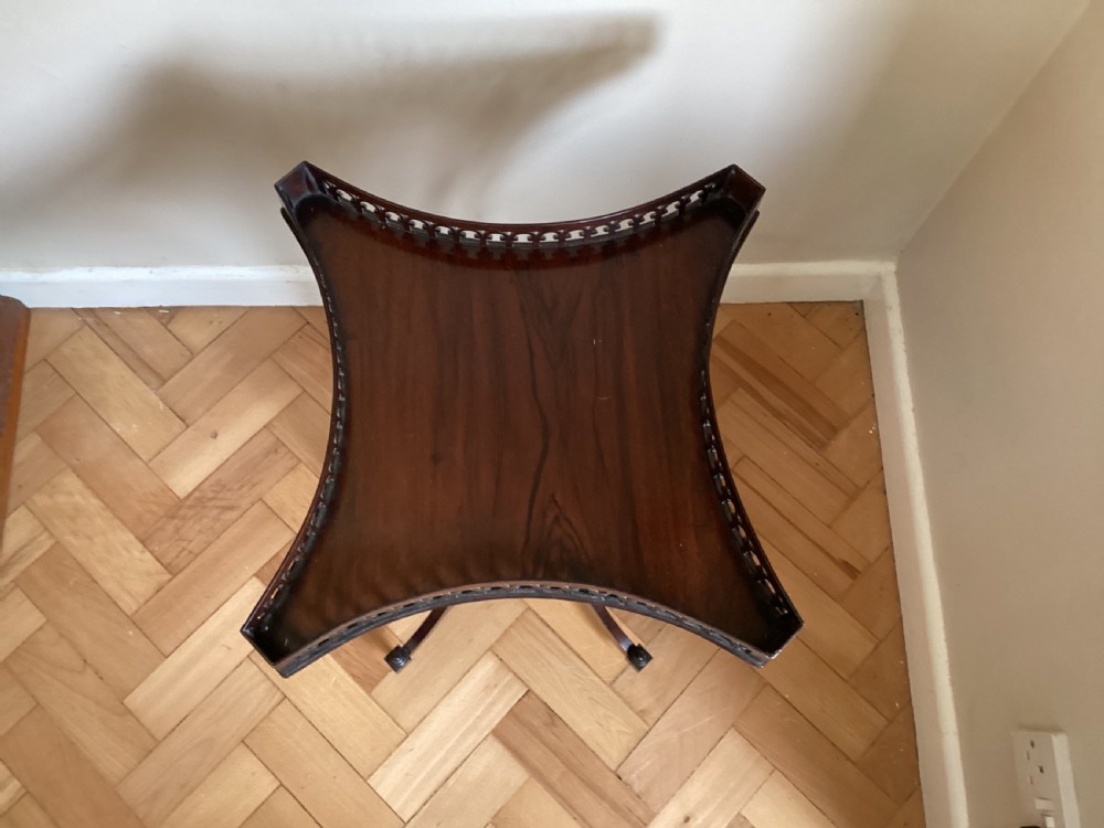 A dark mahogany occasional table featuring a concave square top surrounded by a pierced fretwork gallery, supported by four out-swept legs joined by an X-stretcher. View IV