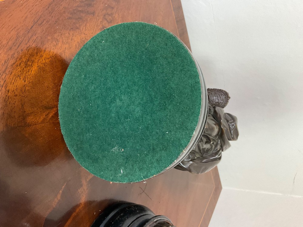 A pair of early 19th-century French patinated bronze figures depicting a man and a woman in period attire on stepped circular bases. View XIX