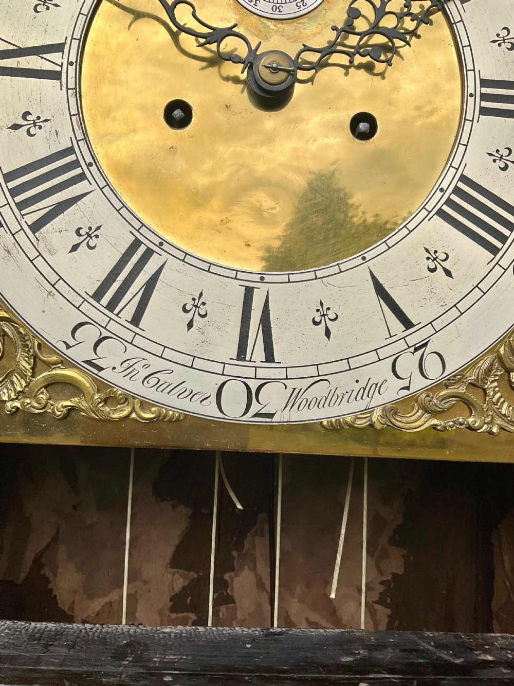 An early Georgian black japanned longcase clock featuring raised gilt Chinoiserie landscapes and figures on the case door, topped with an arched brass dial. View XI