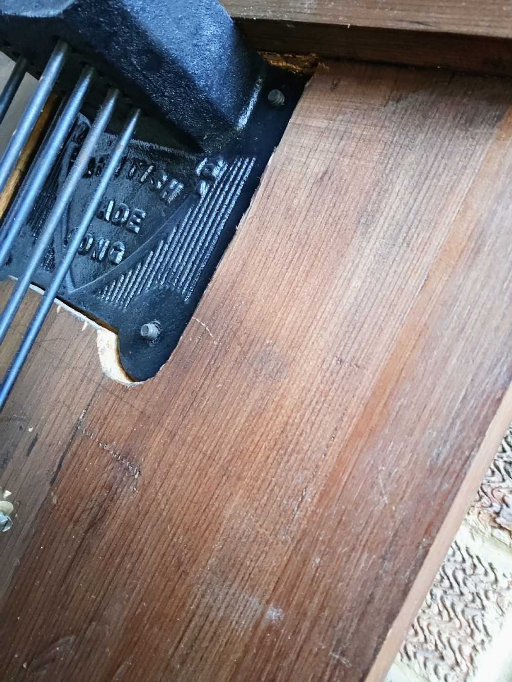 A slim mahogany grandmother longcase clock with a carved top frieze, brass Roman numeral dial, and an arched waist door. View XIV