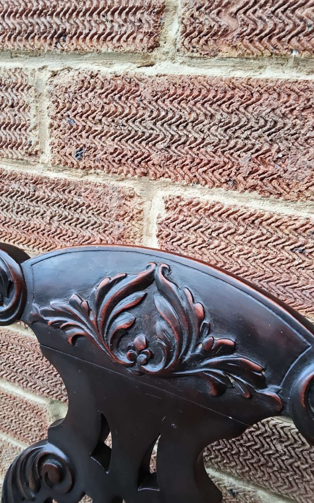 A dark mahogany elbow chair featuring a carved pierced splat back, shaped arms, a brown leather seat, and cabriole legs with ball and claw feet. View IV