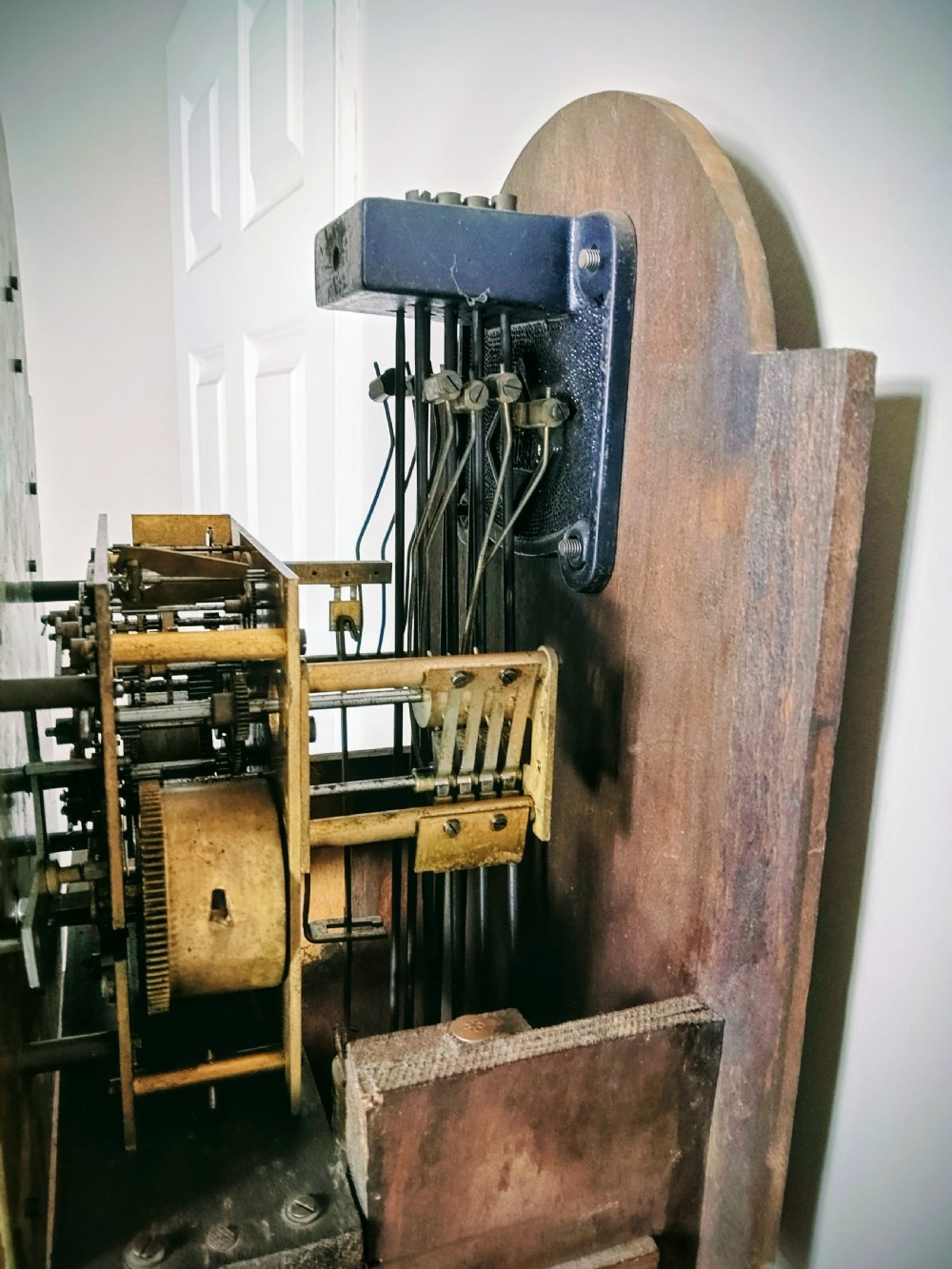 A tall quarter-veneered walnut grandmother longcase clock featuring an arched hood, a brass dial with a Tempus Fugit boss, and a slender trunk door. View XI
