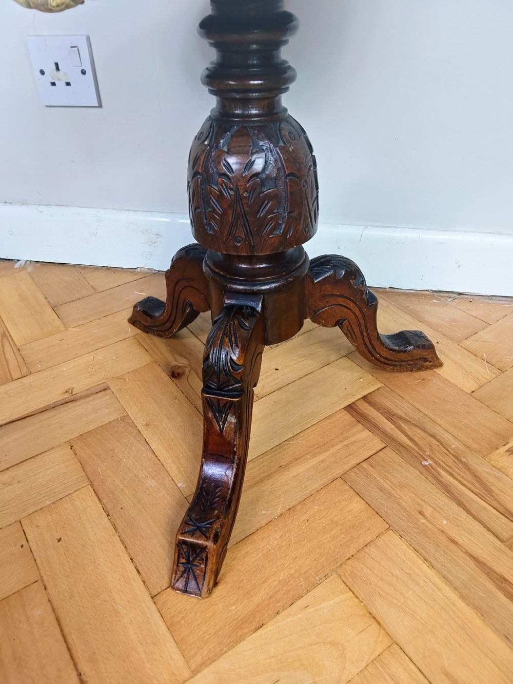 Victorian carved walnut swivel piano stool featuring a button-tufted olive green velvet seat with decorative braid trim and a low curved backrest. View XI