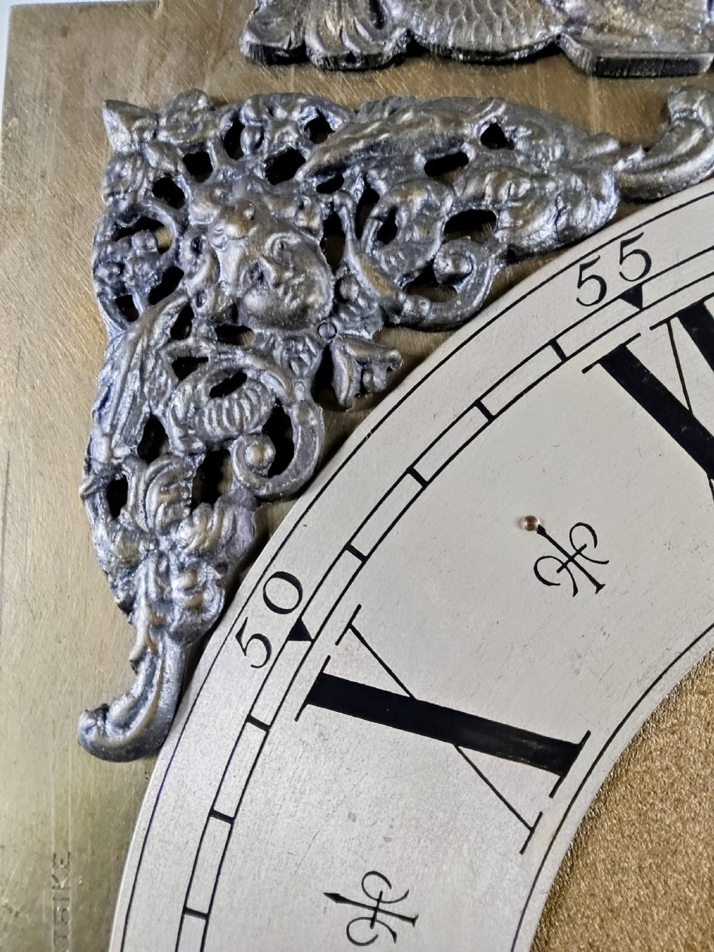 A tall mahogany longcase clock featuring an arched hood, glass door displaying a brass dial with silvered chapter ring, fluted side columns, and a moulded plinth base. View VII