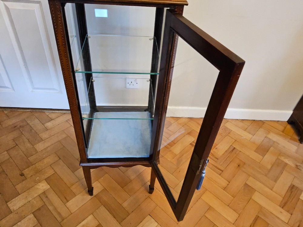 A slender mahogany bijouterie cabinet featuring four glass sides, two glass shelves, satinwood inlay details, and a stepped pagoda top. View VIII