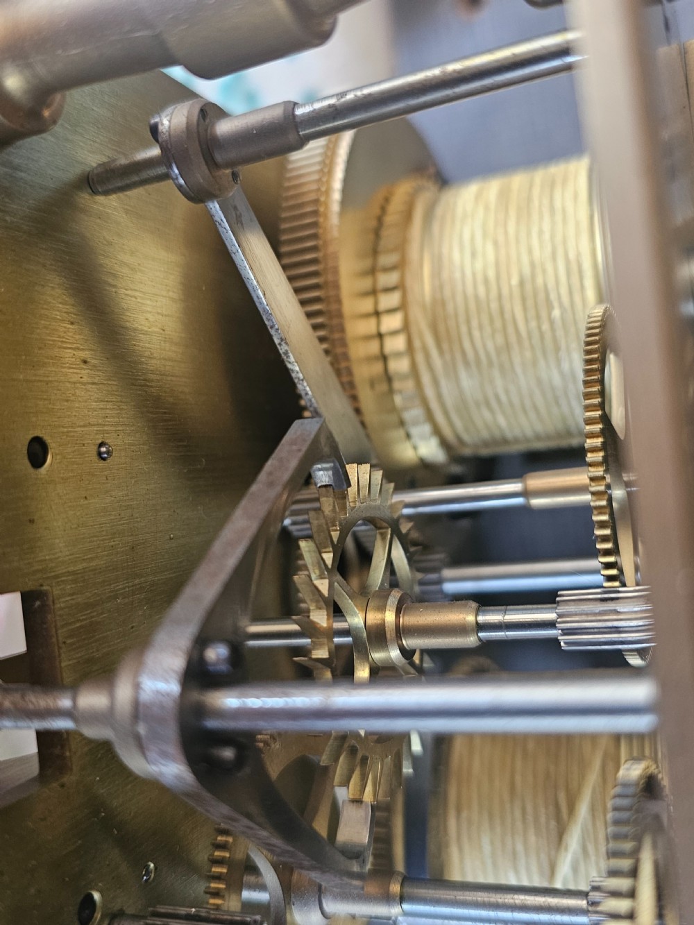 A tall dark oak longcase clock featuring rope twist columns, a square brass dial with silvered chapter ring, and a carved wooden casing. View X