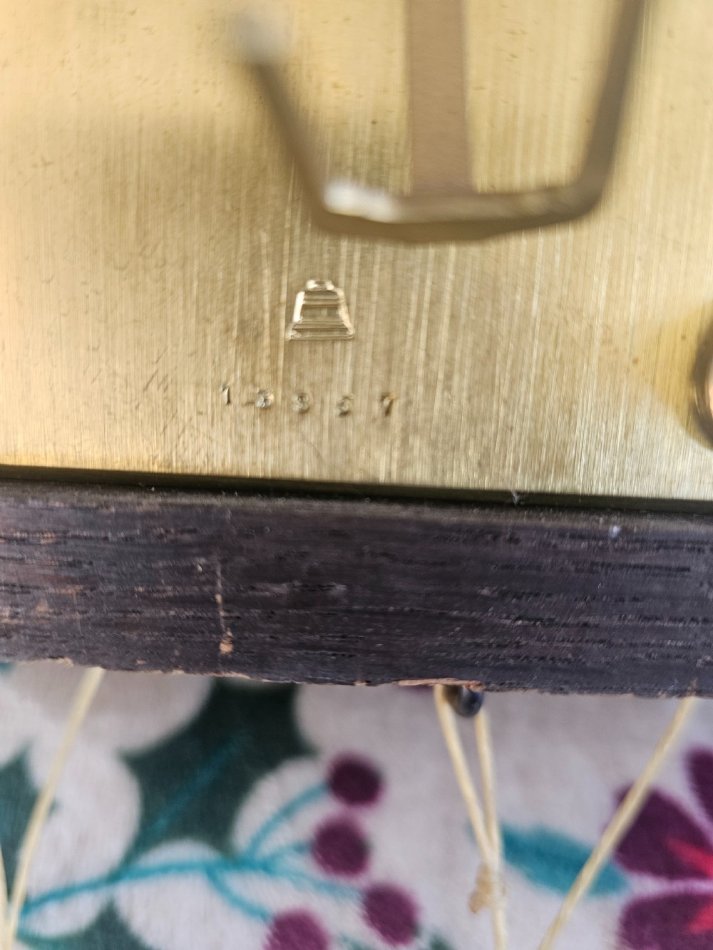A tall dark oak longcase clock featuring rope twist columns, a square brass dial with silvered chapter ring, and a carved wooden casing. View XII