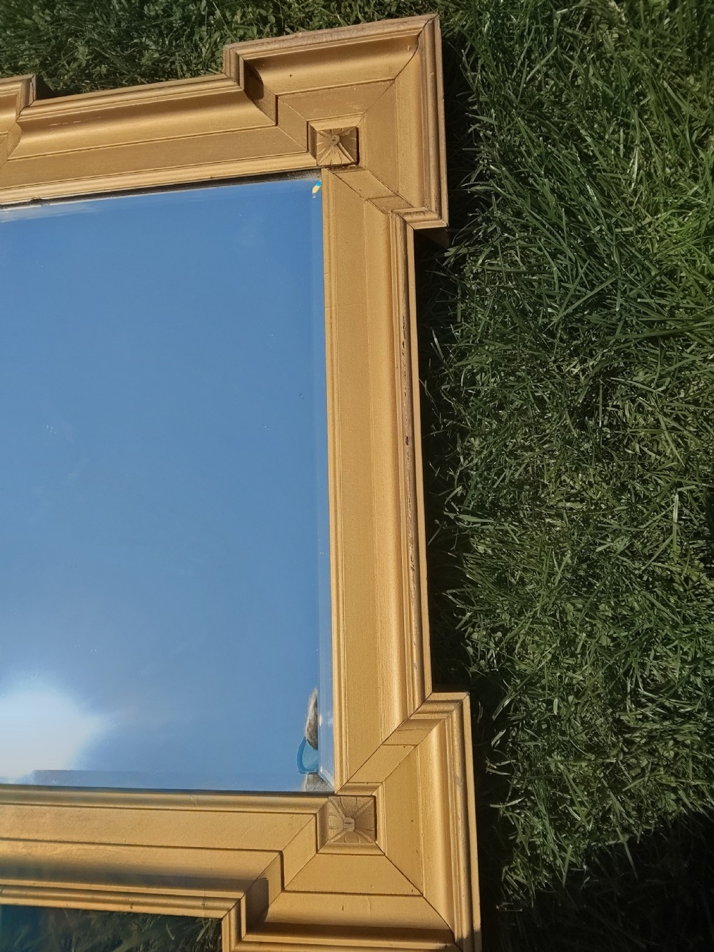 A rectangular Victorian giltwood wall mirror featuring stepped architectural corners and square raised corner bosses. View II