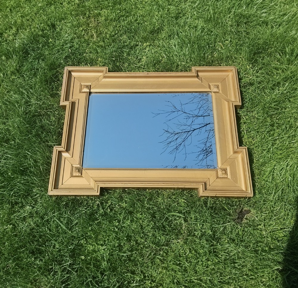 A rectangular Victorian giltwood wall mirror featuring stepped architectural corners and square raised corner bosses. View IV