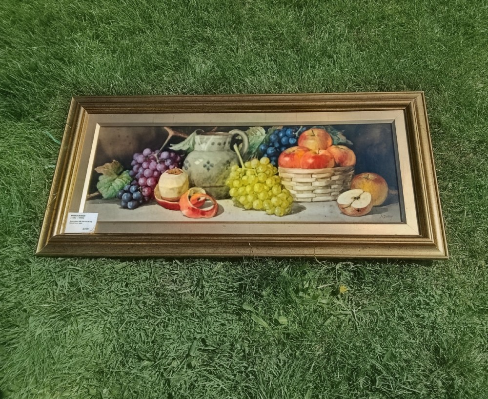 A wide framed watercolour painting depicting a still life arrangement of grapes, apples, a peeled fruit, a ceramic jug, and a woven basket.