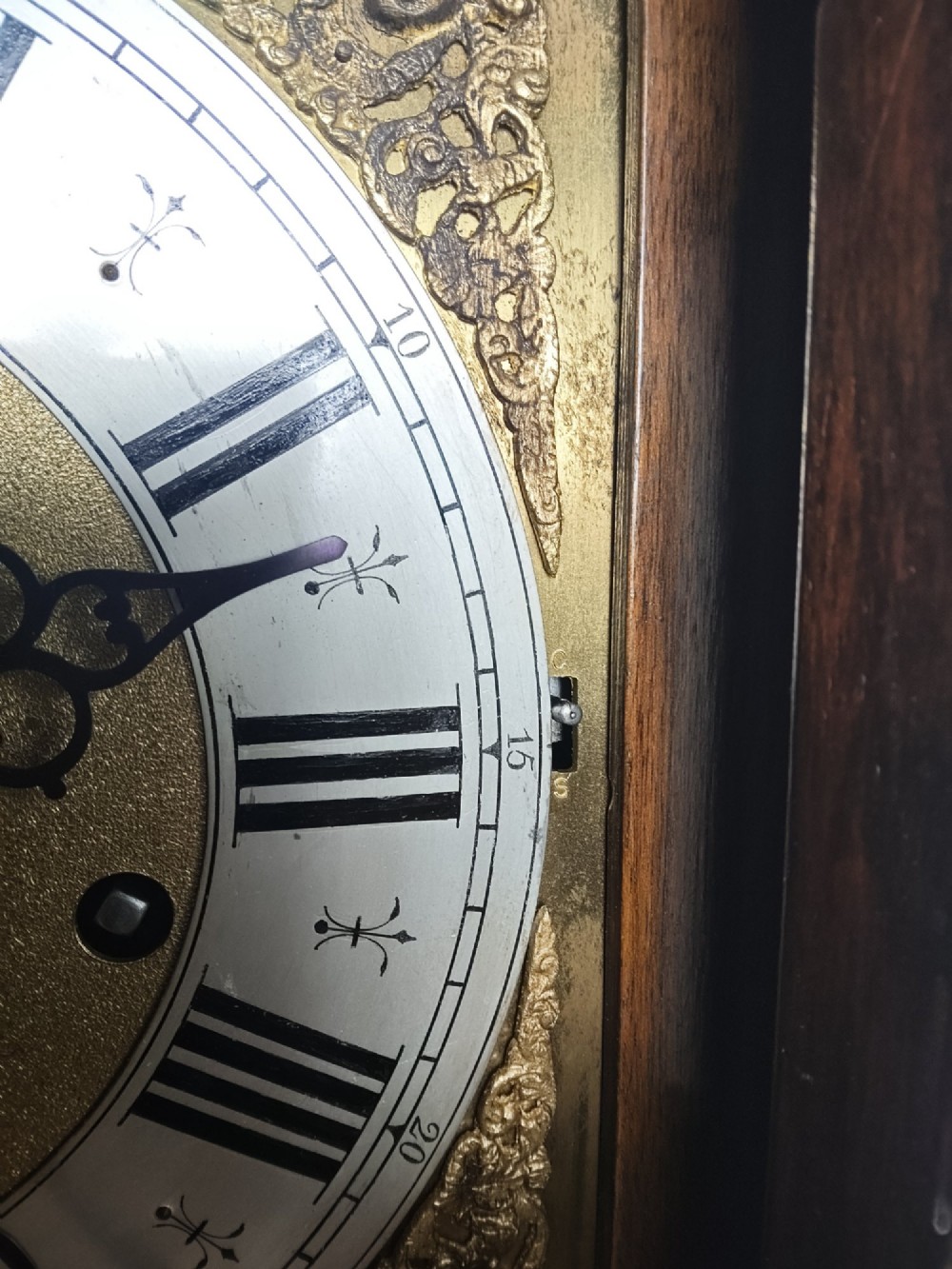 A tall slim figured walnut grandmother longcase clock featuring an arched hood, brass and silvered dial, and a polished wood trunk. View XI