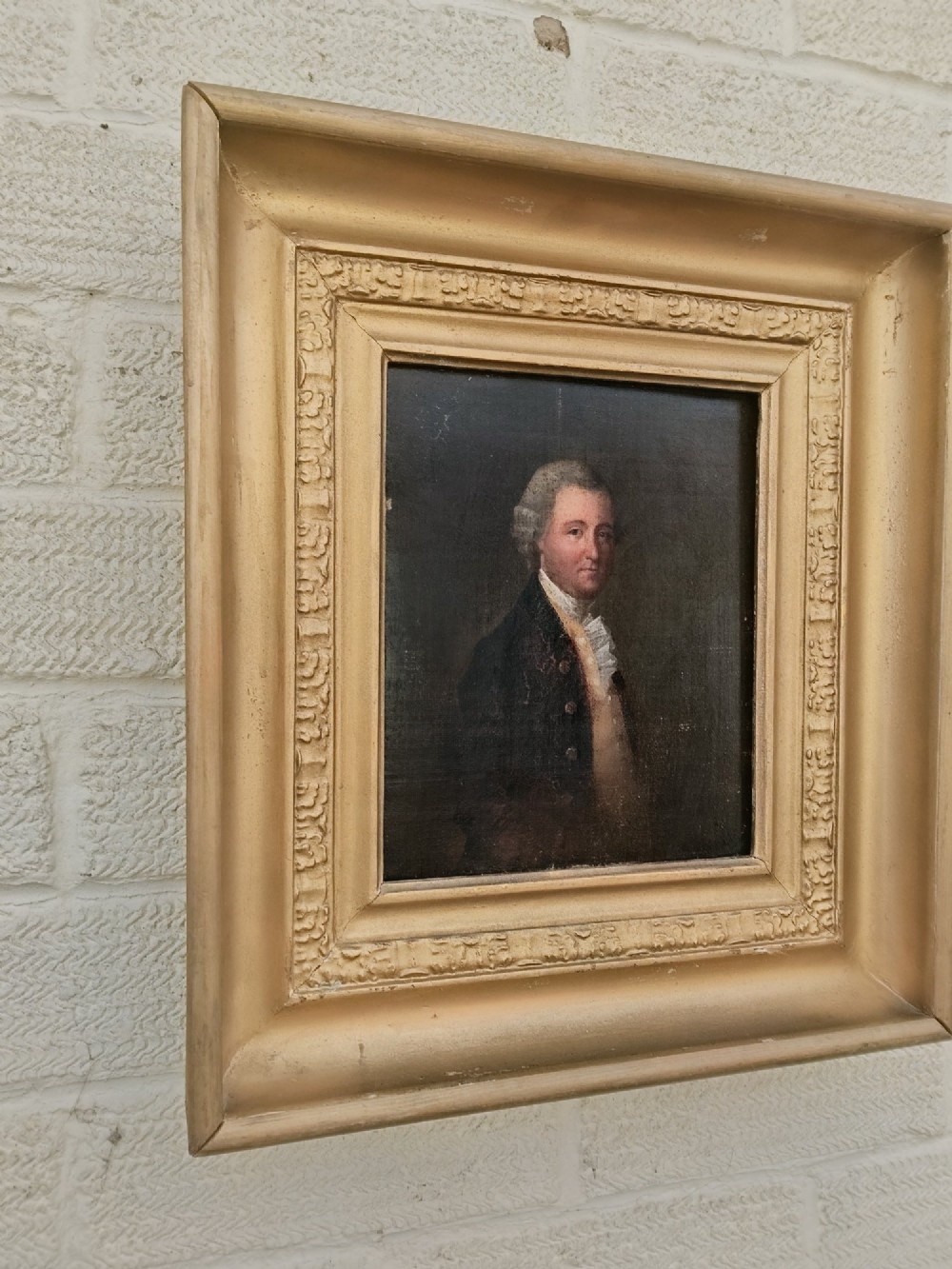 A nineteenth-century oil portrait of a gentleman dressed in period attire set within a deep gilded moulded wooden frame. View III