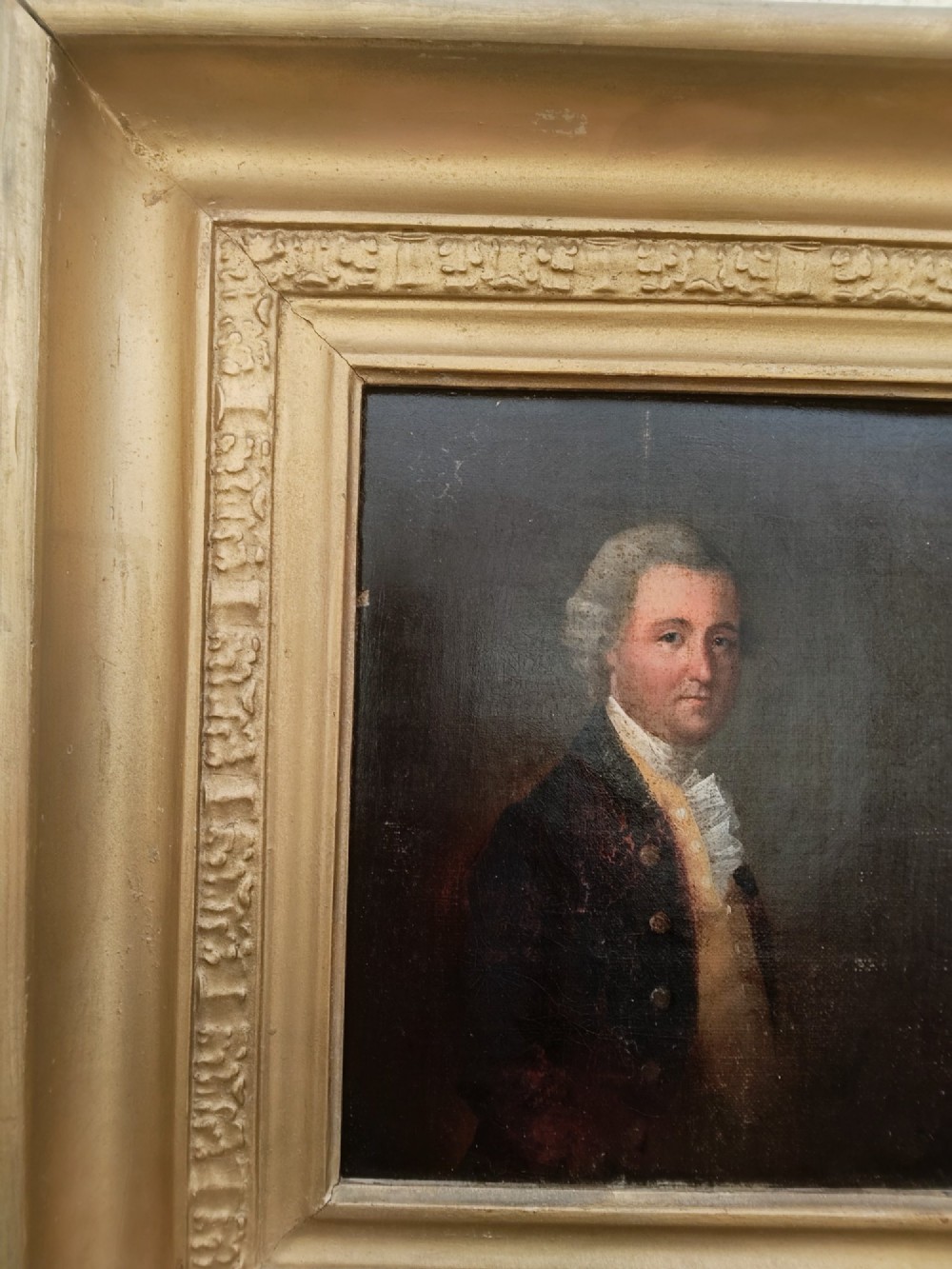 A nineteenth-century oil portrait of a gentleman dressed in period attire set within a deep gilded moulded wooden frame. View VI