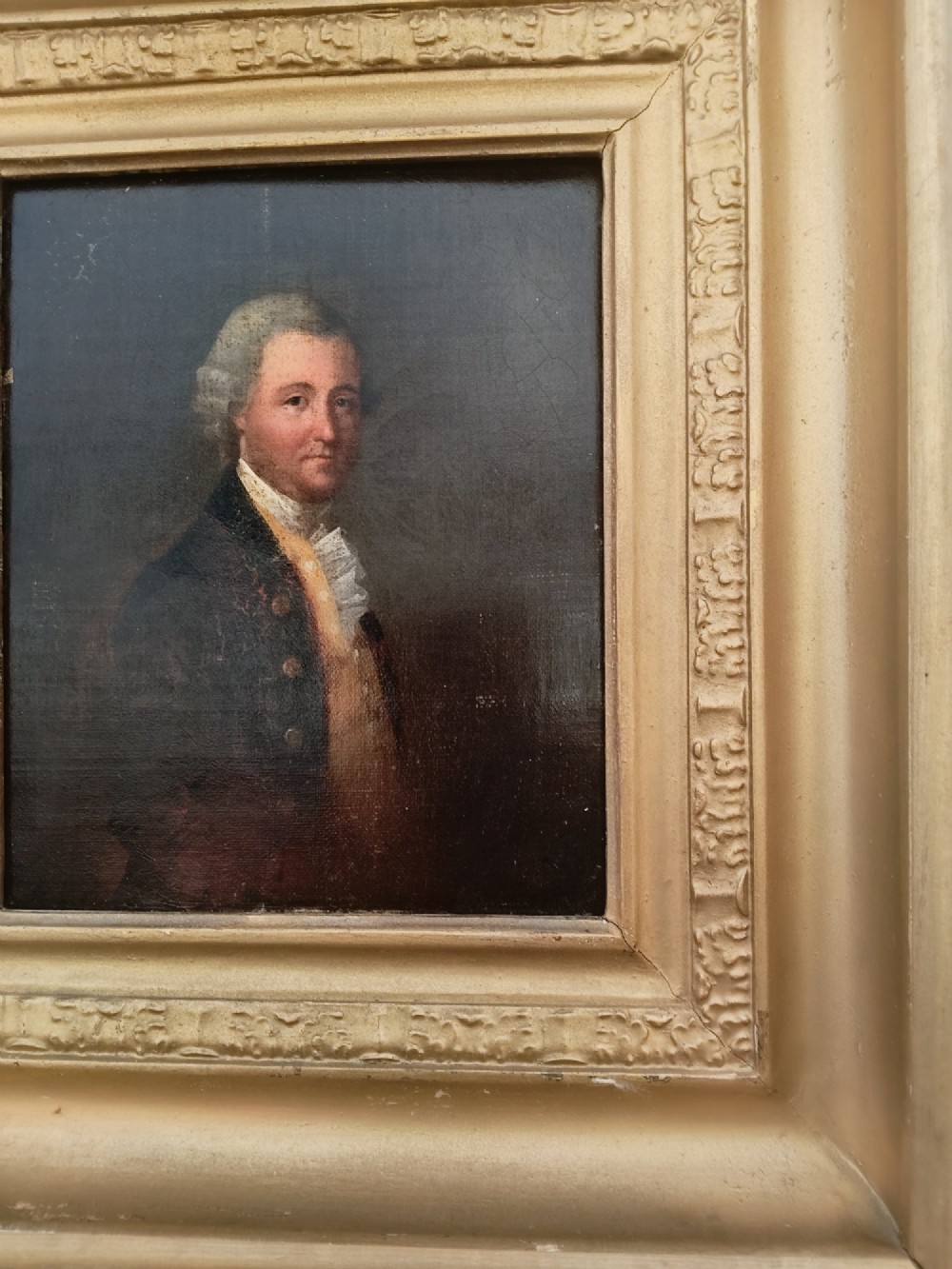 A nineteenth-century oil portrait of a gentleman dressed in period attire set within a deep gilded moulded wooden frame. View VII