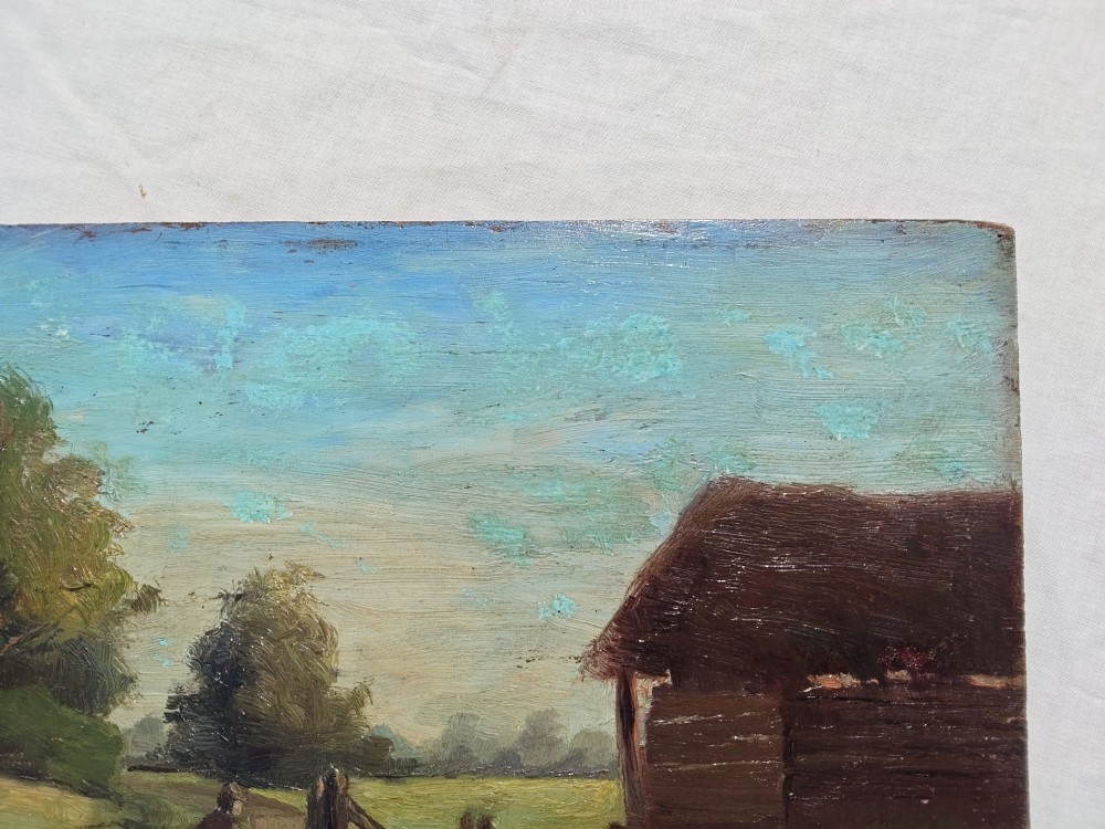 An antique English School oil painting on a wooden board depicting a rural landscape with a figure beside a dirt path, wooden fence, and timber barn under a light blue sky. View V