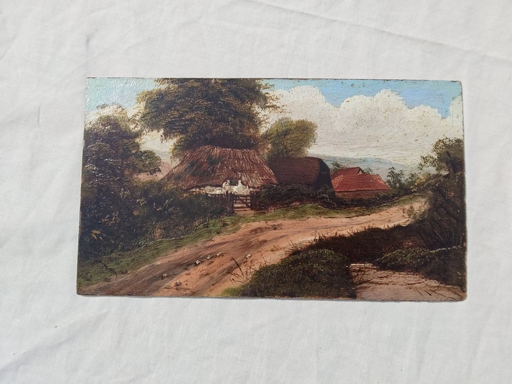 An antique oil painting on card depicting a rural English thatched cottage along a dirt path, set inside an ornate gilt frame. View II