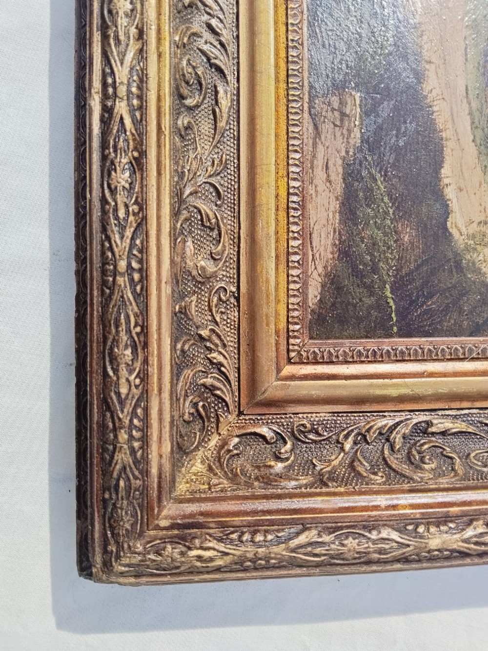 An antique oil painting on card depicting a rural English thatched cottage along a dirt path, set inside an ornate gilt frame. View VII
