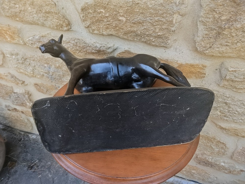 A dark brown cast bronze sculpture depicting a saddled standing horse positioned on an integral rectangular base. View VII
