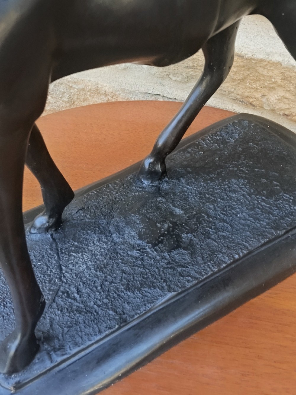 A dark brown cast bronze sculpture depicting a saddled standing horse positioned on an integral rectangular base. View VIII
