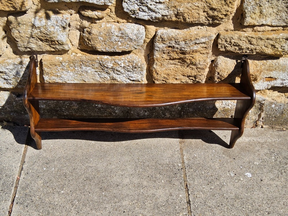 A 19th-century dark walnut wall shelf unit featuring two tiers and shaped serpentine side supports. View IV