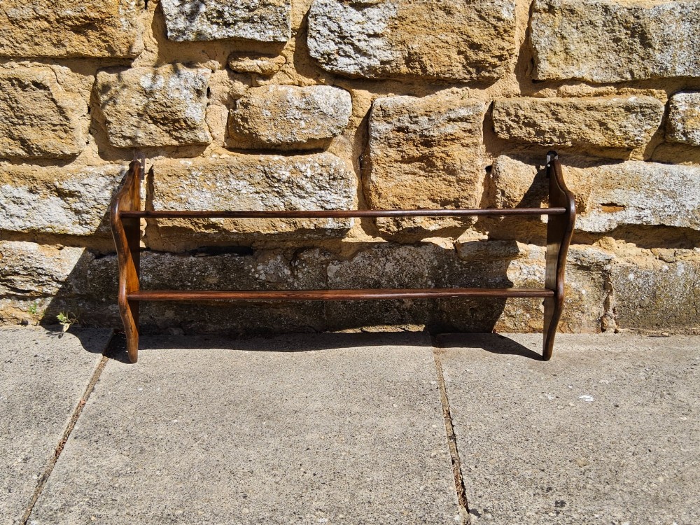 A 19th-century dark walnut wall shelf unit featuring two tiers and shaped serpentine side supports. View V
