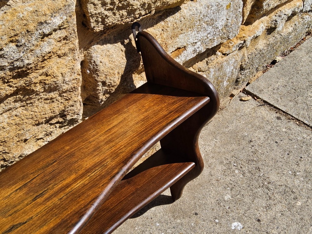 A 19th-century dark walnut wall shelf unit featuring two tiers and shaped serpentine side supports. View II