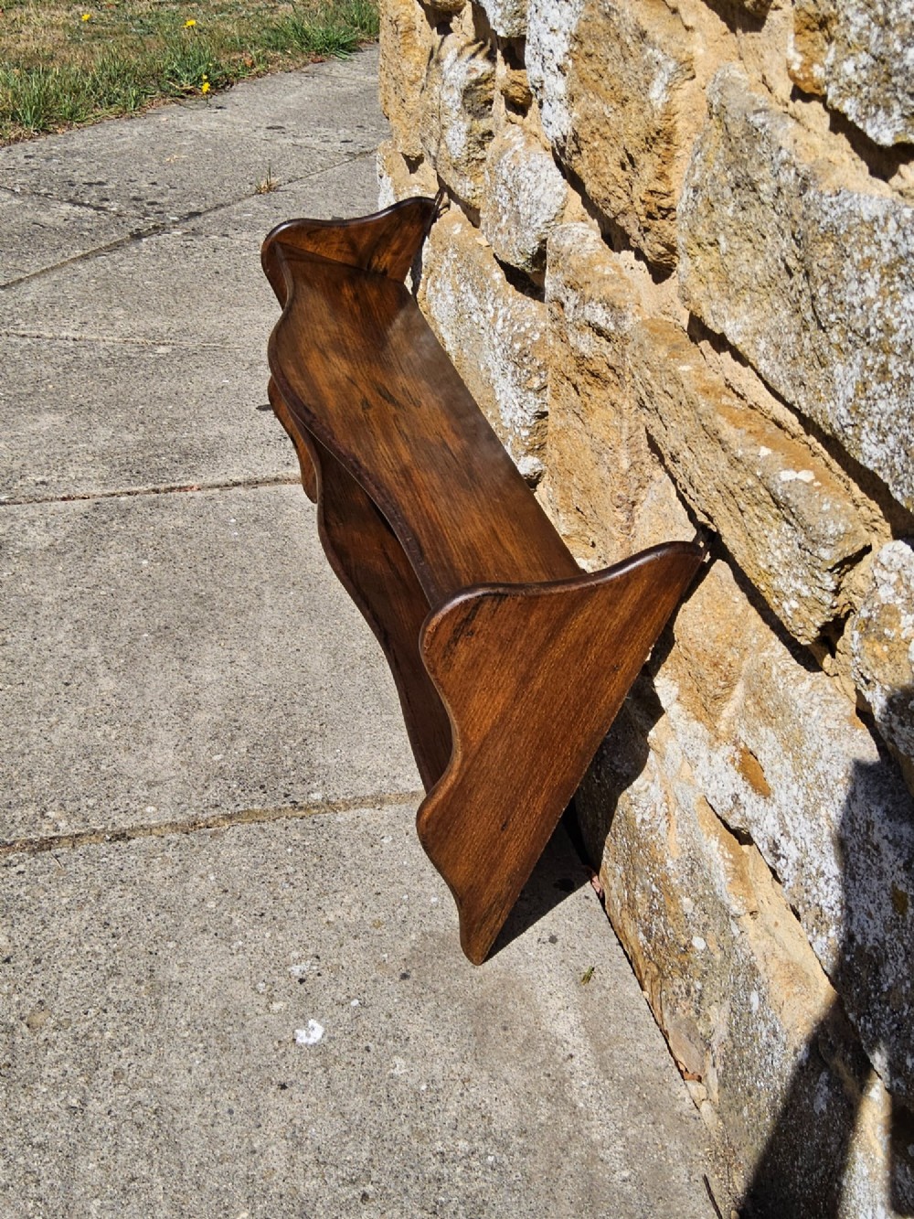A 19th-century dark walnut wall shelf unit featuring two tiers and shaped serpentine side supports. View VI