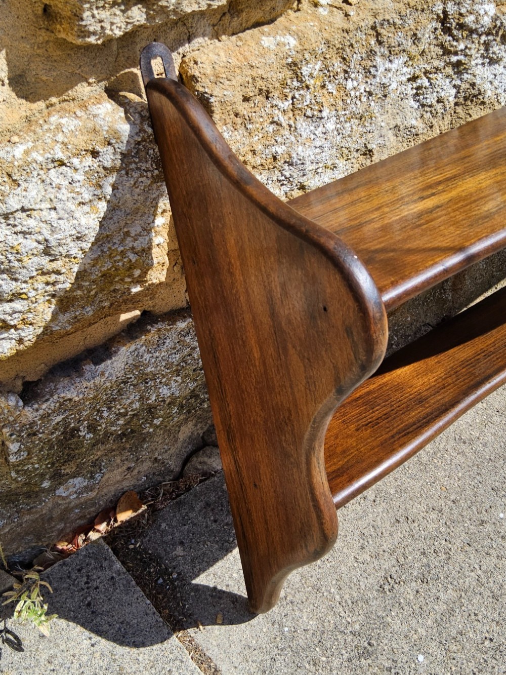 A 19th-century dark walnut wall shelf unit featuring two tiers and shaped serpentine side supports. View VII