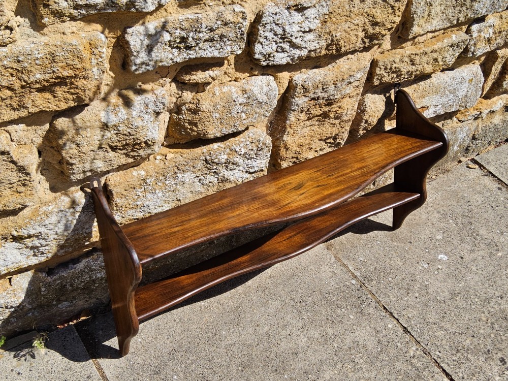 A 19th-century dark walnut wall shelf unit featuring two tiers and shaped serpentine side supports. View IX