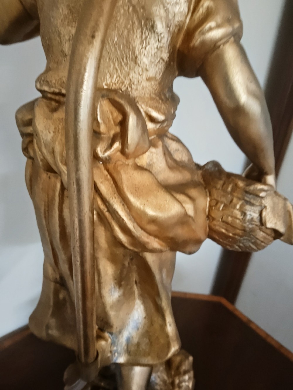 A pair of gold gilt metal table lamps depicting standing figures of French rustic workers mounted on square wooden bases. View XV
