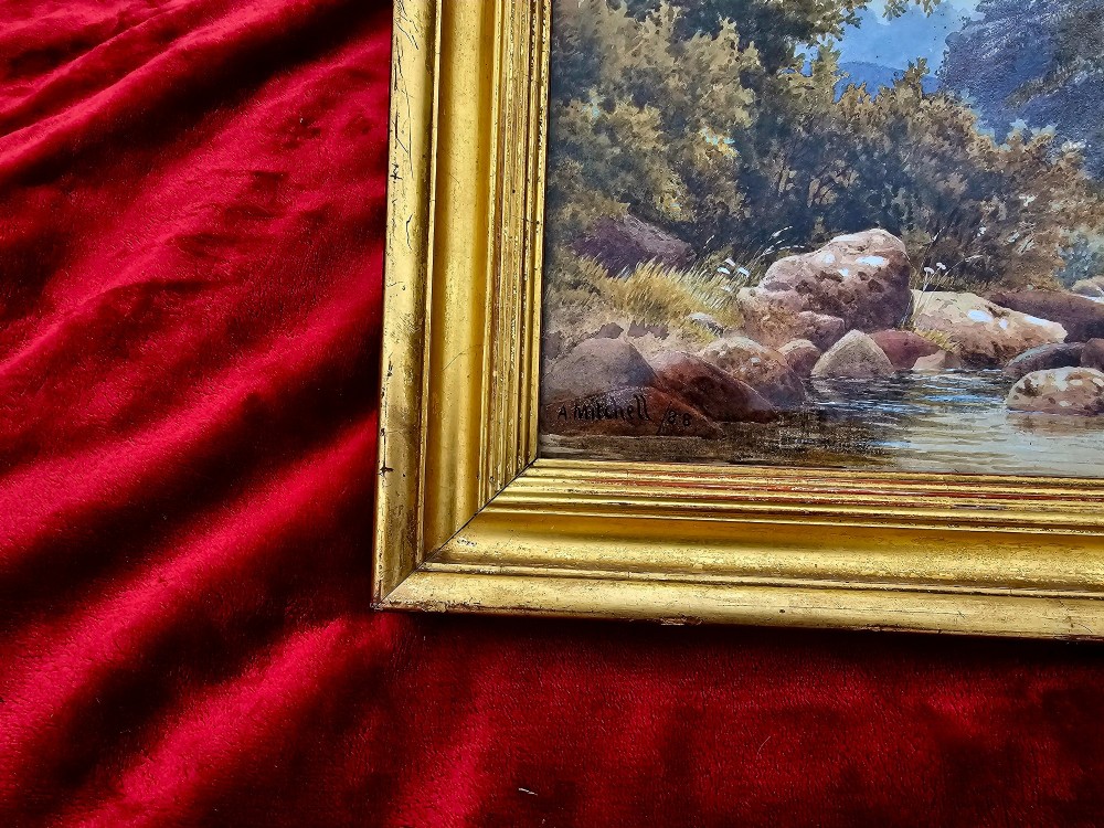 A nineteenth-century watercolour landscape painting depicting a rocky river stream surrounded by foliage, mounted in a moulded gold gilt frame. View III