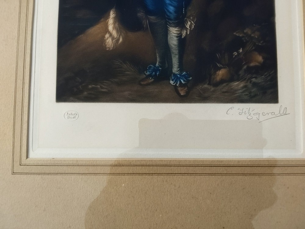 A framed colour portrait print of Thomas Gainsboroughs The Blue Boy, set within a wide beige mount and a gold giltwood frame topped with a bow cresting. View XII