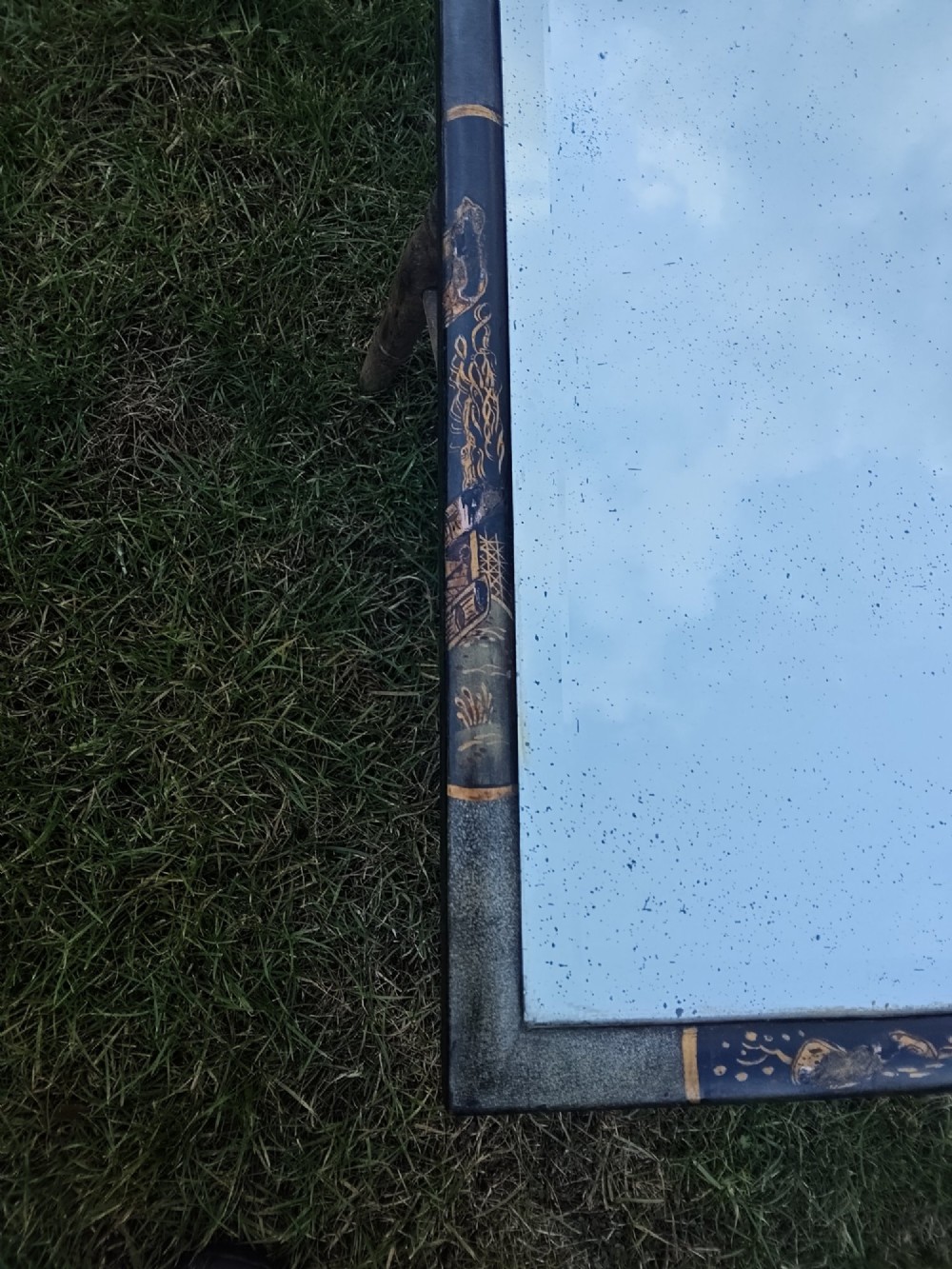 A 19th-century shaped wall mirror featuring a black lacquered frame with hand-painted gold Chinoiserie motifs and a bevelled mirror plate. View IX