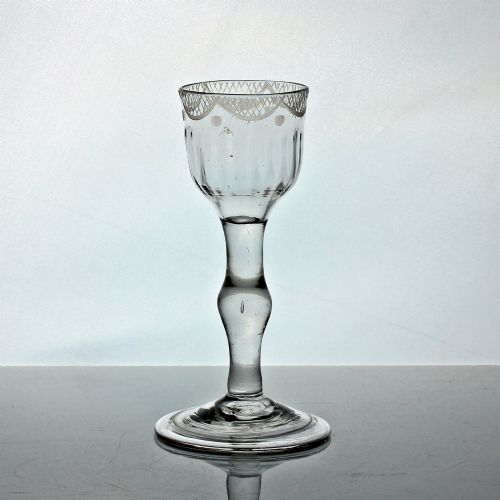 GEORGIAN SWAG AND TAIL ENGRAVED BALUSTROID STEM WINE GLASS