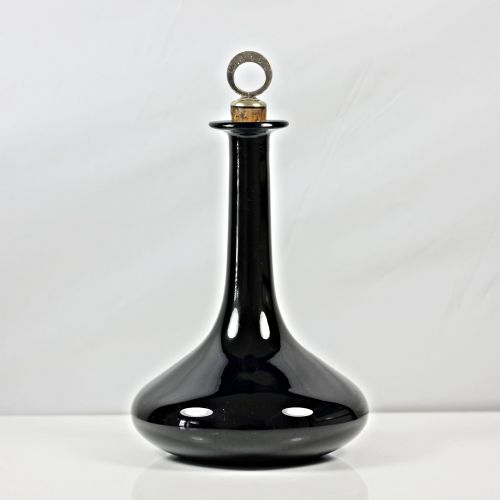 fig 1. A pair of deep cobalt Bristol blue glass mell-shaped decanters featuring slender necks and metal ring stoppers labelled Claret and Brandy.