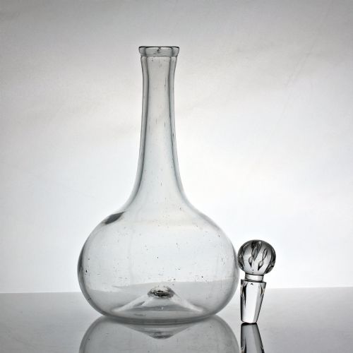 fig 1. An 18th-century Georgian clear hand-blown glass shaft and globe decanter featuring a spherical base, long slender neck, and matching glass ball stopper.