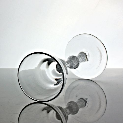 fig 1. A hand-blown Georgian lead glass goblet featuring a pan-top bowl, a multi-spiral air twist stem with a central knop, and a wide conical foot.