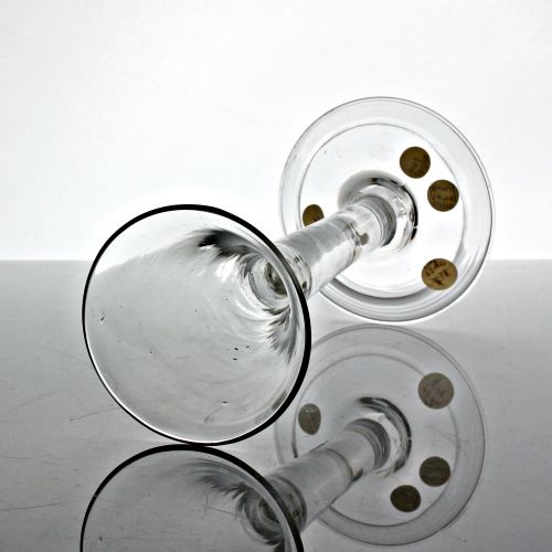 fig 1. A clear Georgian glass wine goblet featuring a tall trumpet bowl, a solid plain stem, and a wide folded conical foot.