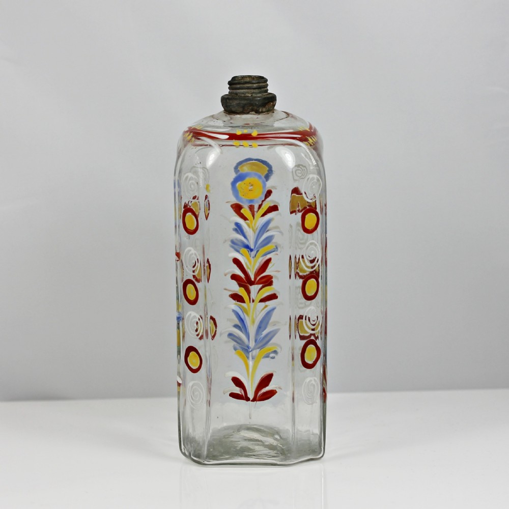 An 18th-century rectangular clear glass schnapps flask featuring hand-painted polychrome floral enamelling and a threaded metal pewter cap. View II