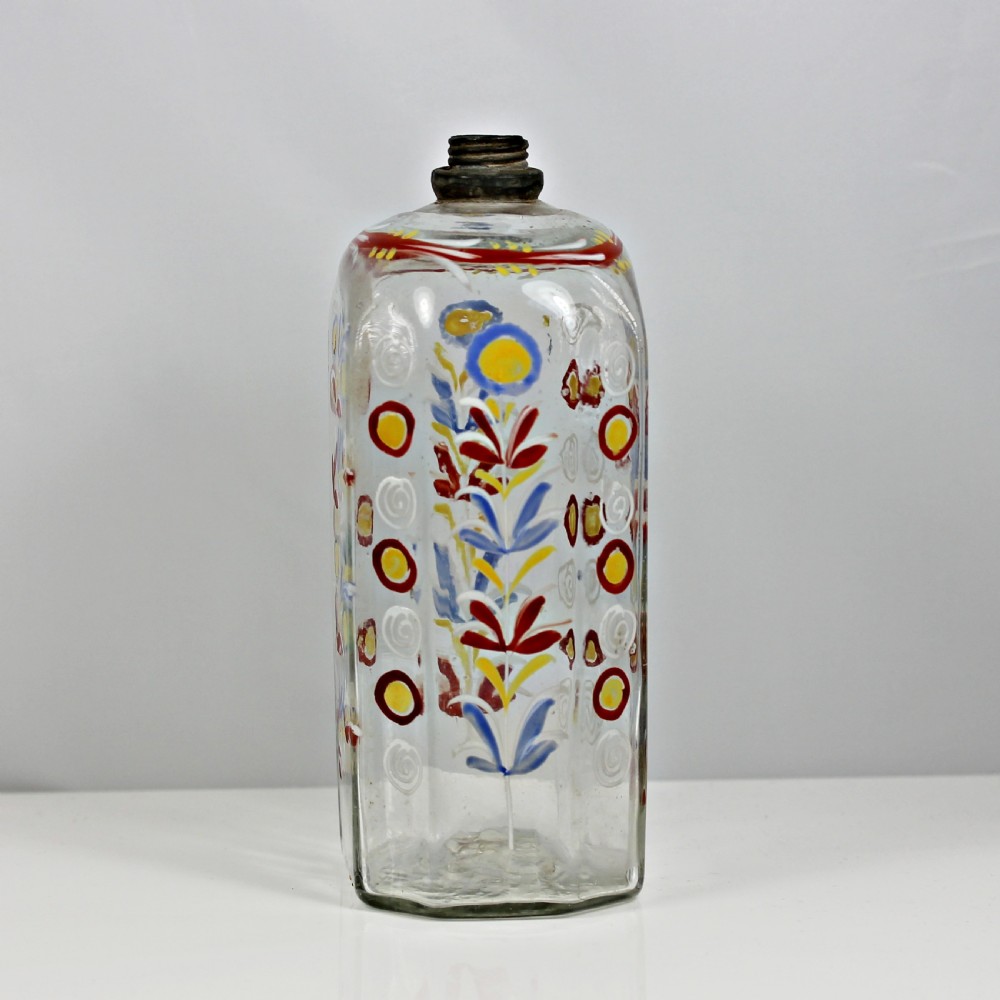 An 18th-century rectangular clear glass schnapps flask featuring hand-painted polychrome floral enamelling and a threaded metal pewter cap. View IV