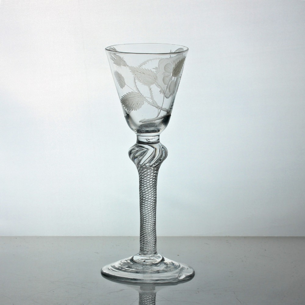 An 18th-century clear glass wine goblet featuring a Jacobite rose engraving on the rounded funnel bowl and a multi-spiral air twist stem. View III