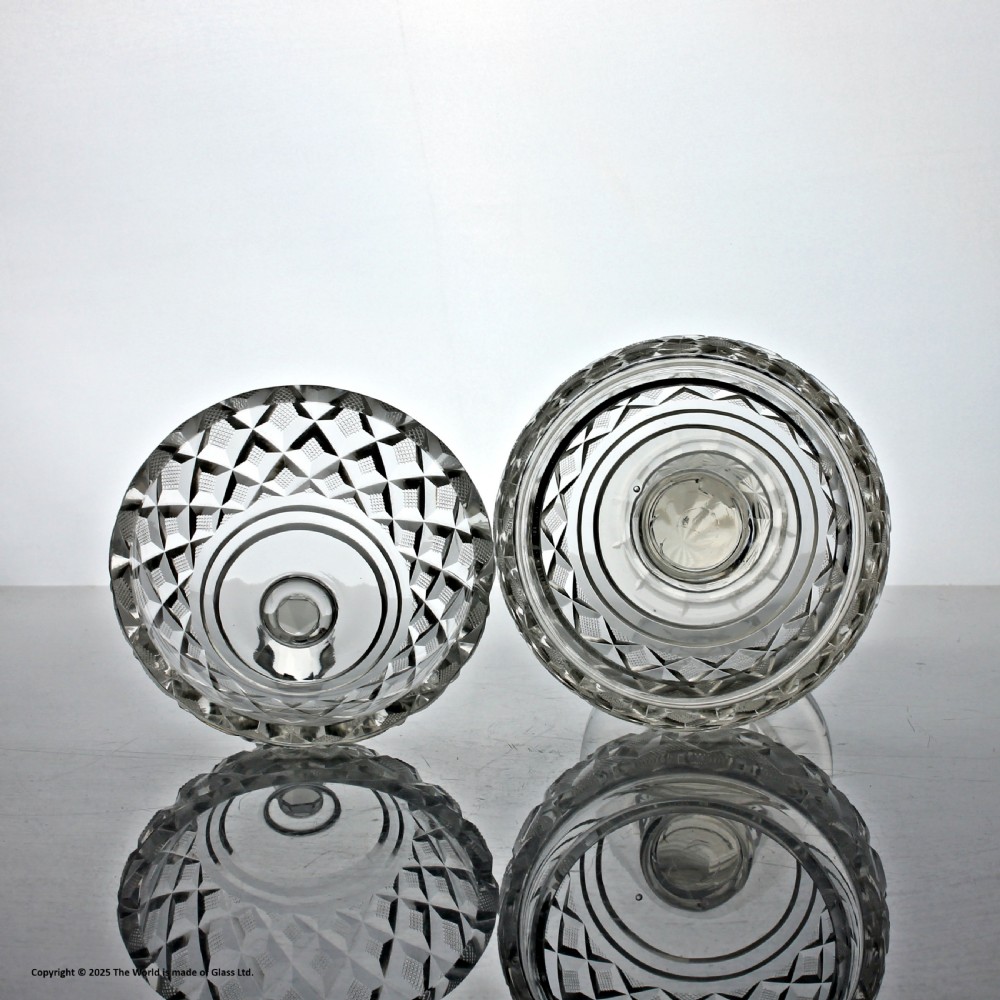 An Edwardian clear cut glass lidded bowl featuring diamond facets, a pedestal stem, and a faceted top finial. View II
