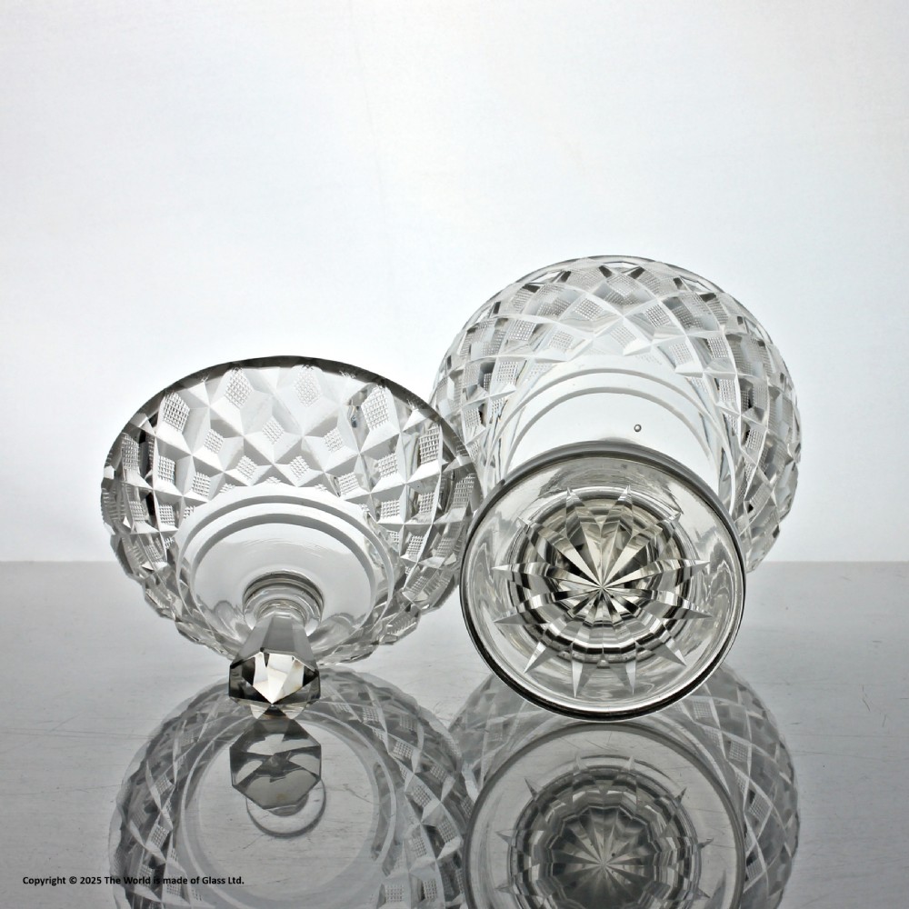 An Edwardian clear cut glass lidded bowl featuring diamond facets, a pedestal stem, and a faceted top finial. View III
