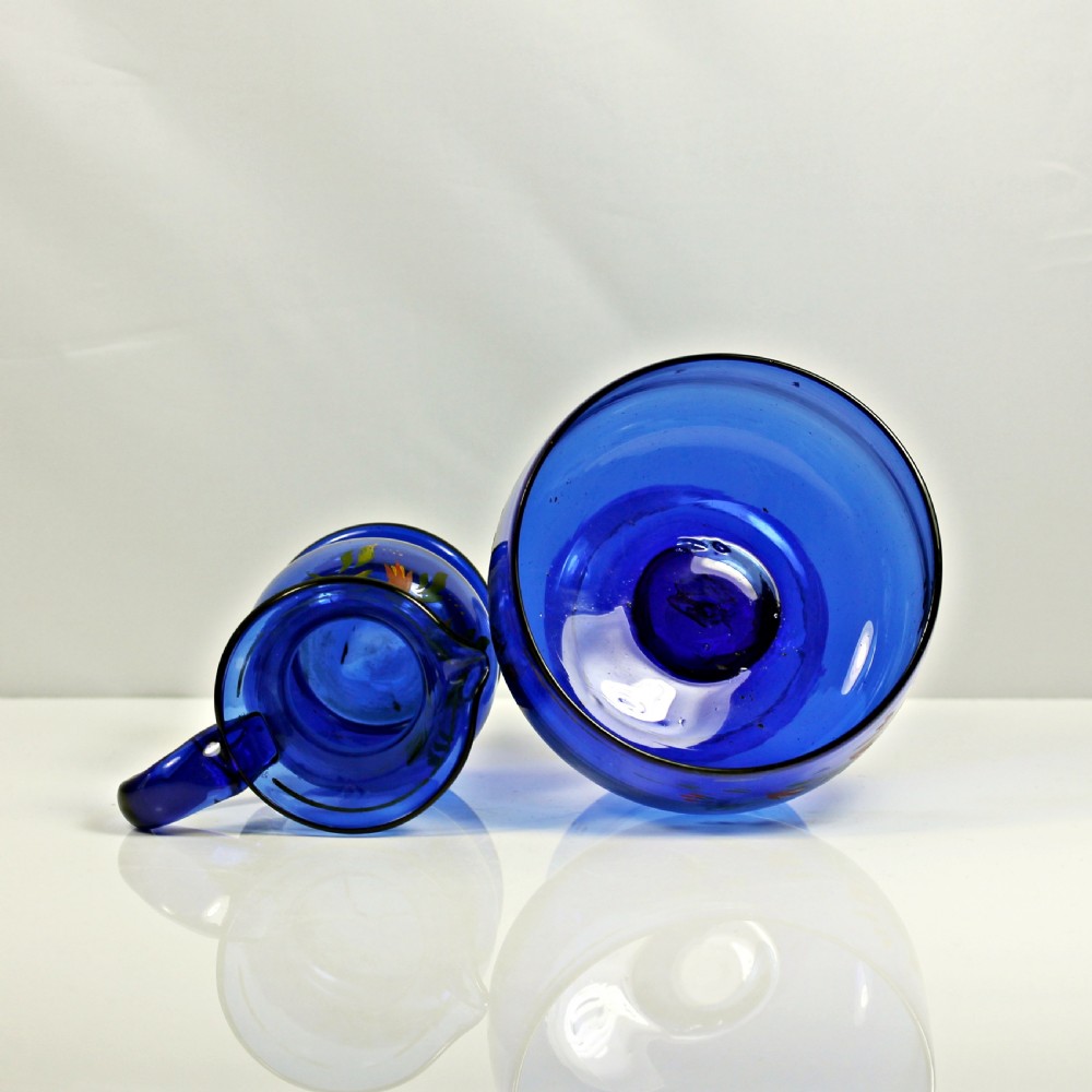 A hand-painted Bristol blue glass cream jug and matching pedestal sugar bowl decorated with floral motifs. View III