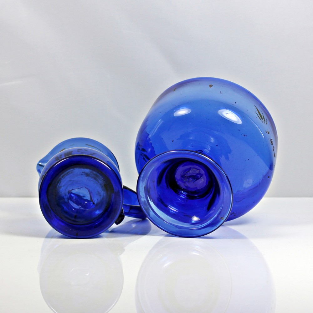 A hand-painted Bristol blue glass cream jug and matching pedestal sugar bowl decorated with floral motifs. View IV